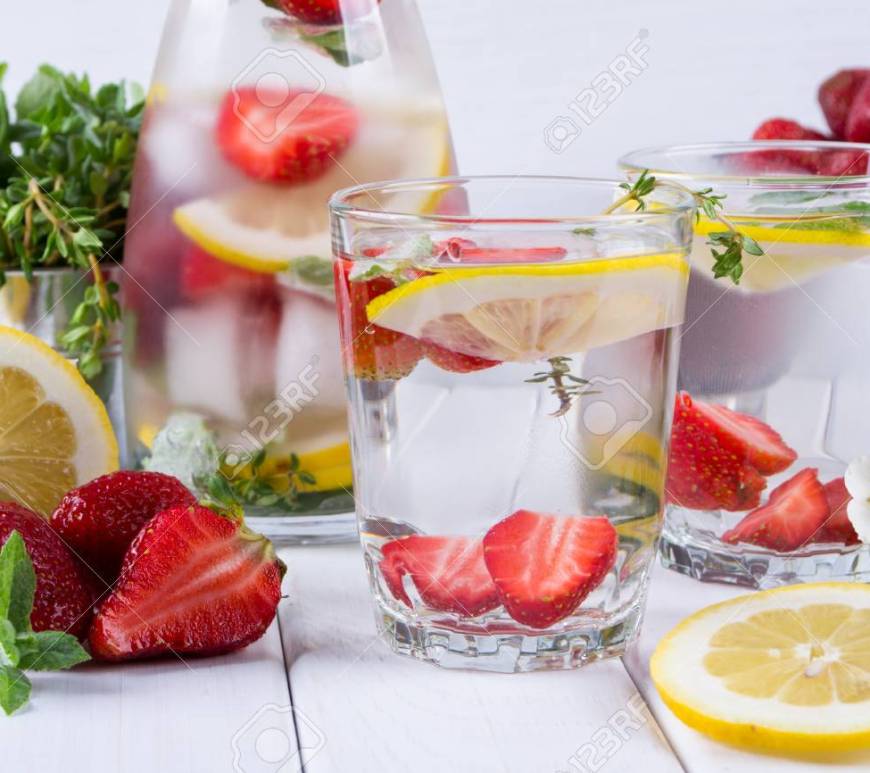infused water glass pitcher two glasses strawberries lemon slices