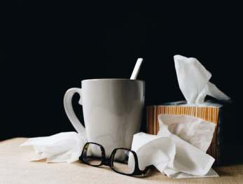 cold remedies white mug glasses tissue box